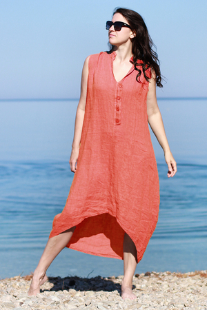 Airy linen summer women's dress for lovers of natural nature style. one color design midi length with extended back